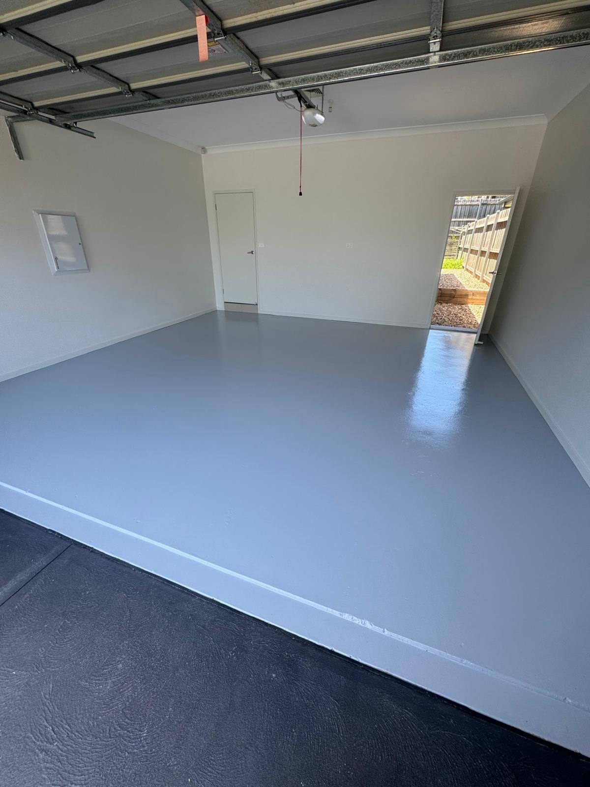 Garage with a freshly coated grey floor and white walls