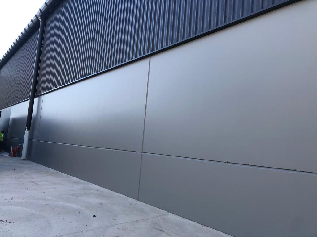 Commercial building wall cladding freshly painted charcoal